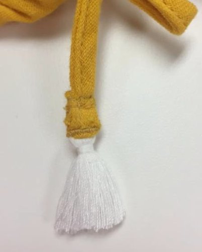 image illustrates example of tassel attached to a drawstring.  